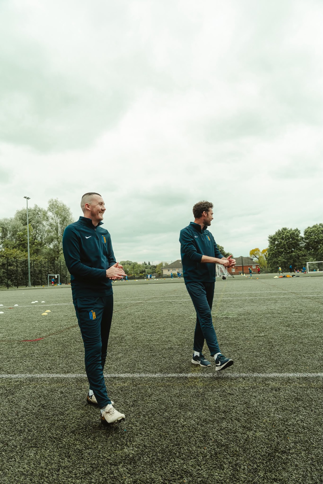 Richard and Harry on the training pitch in RH10 kit